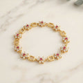 Gold-Tone Flower Link Bracelet with Pink Stones, Crystal Petals and Square Accents