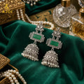 Oxidized Silver Jhumka Earrings – Deep Green Stone & Pearl Drops