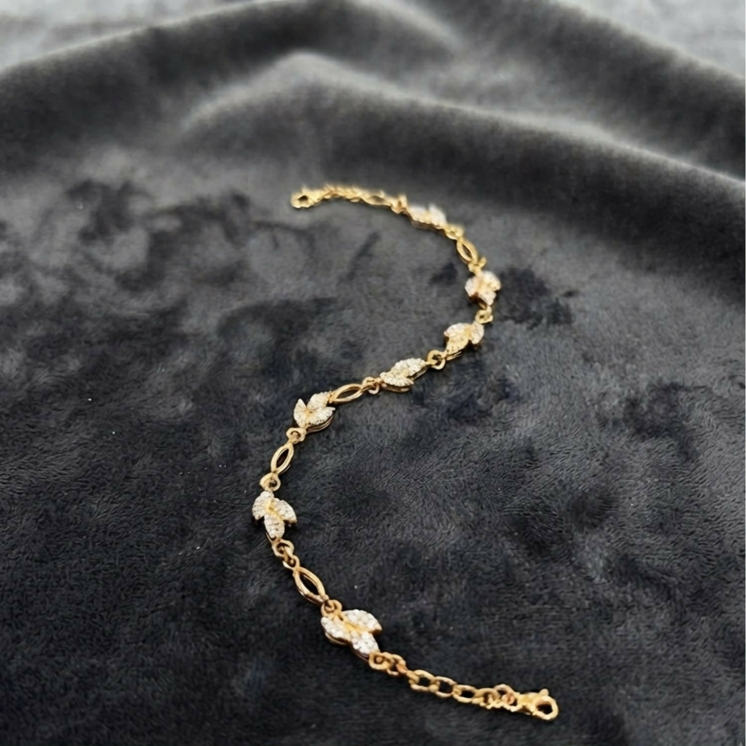Delicate Gold-Tone Three Leaf Bracelet with Crystal Accents and Adjustable Chain